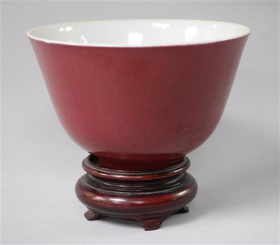 A Chinese red glazed tea bowl on stand 10.5cm